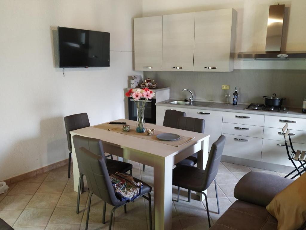 a kitchen with a wooden table and chairs and a kitchen with a kitchen at Casa per vacanze in Meana di Susa in Meana di Susa