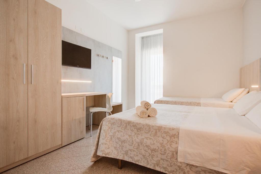 Postel nebo postele na pokoji v ubytování Hotel Olympia