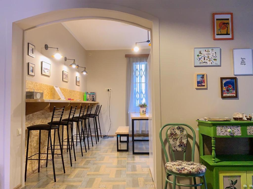 a bar with a row of stools in a room at Hostel 47 in Batumi