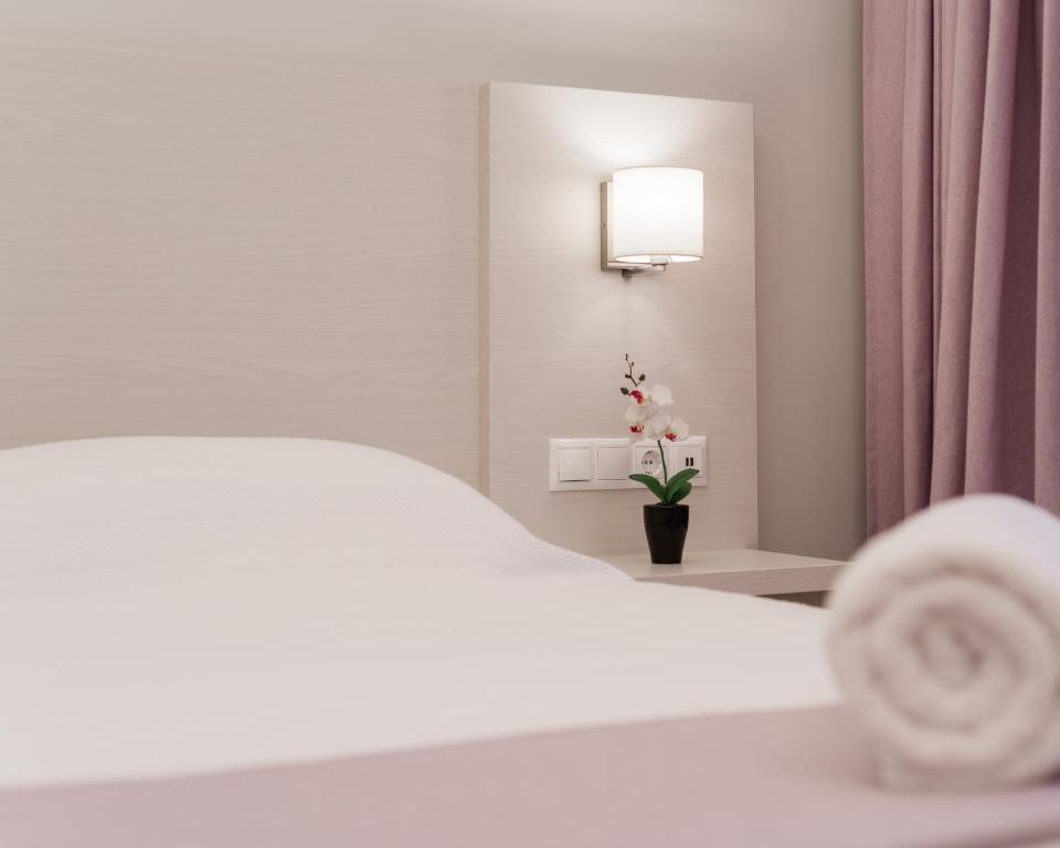 Postel nebo postele na pokoji v ubytování Poseidonio Hotel