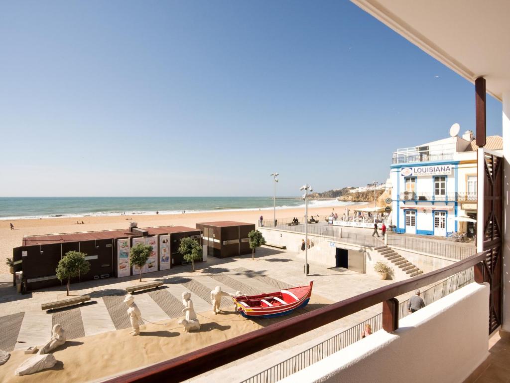a view of the beach from the balcony of a building at Apartamentos Edificio Albufeira - Alojamento Local in Albufeira