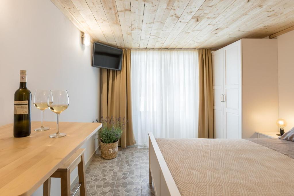 a bedroom with a bed and two glasses of wine at Park Residence in Split