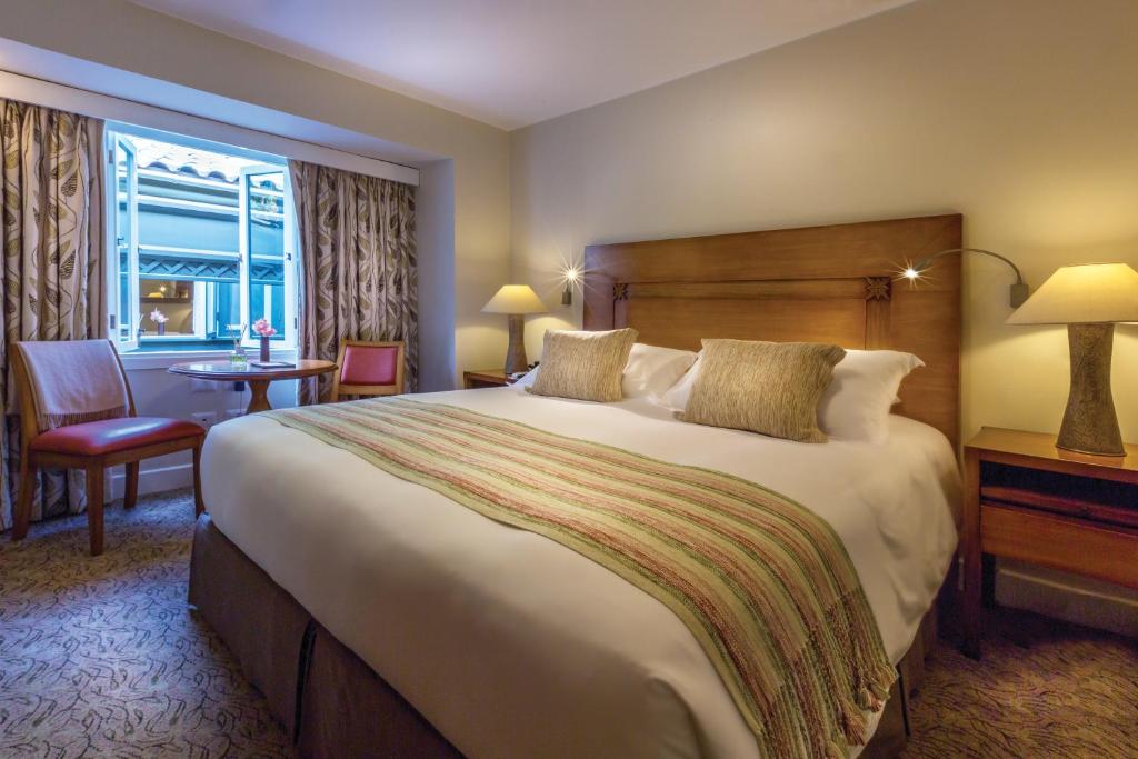 a hotel room with a large bed and a window at Sanctuary Lodge, A Belmond Hotel, Machu Picchu in Machu Picchu