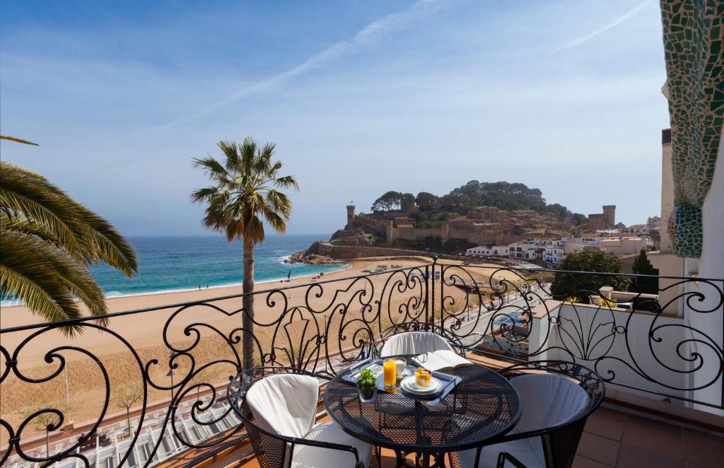 stół i krzesła na balkonie z widokiem na ocean w obiekcie Hotel Diana w Tossa de Mar