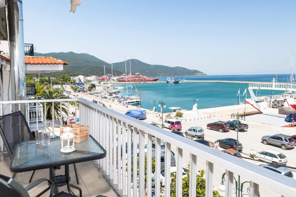 a balcony with a table and a view of a marina at Promenade Sea View Apartment in Limenas