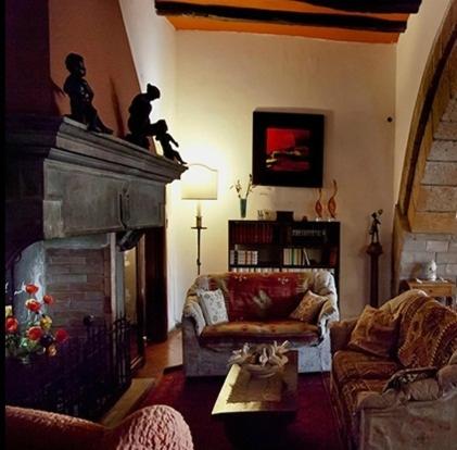 a living room with a couch and a fireplace at B&B Ippolito in Orvieto
