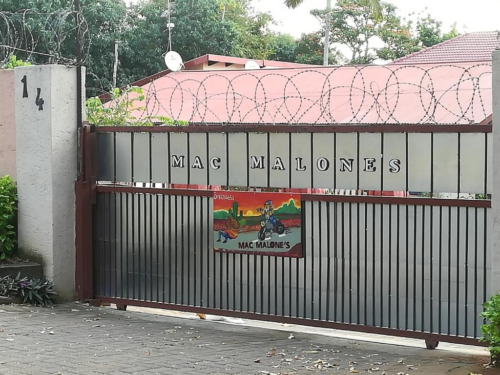 a gate with a sign that reads naja malinois at Mac Malone's in Nelspruit