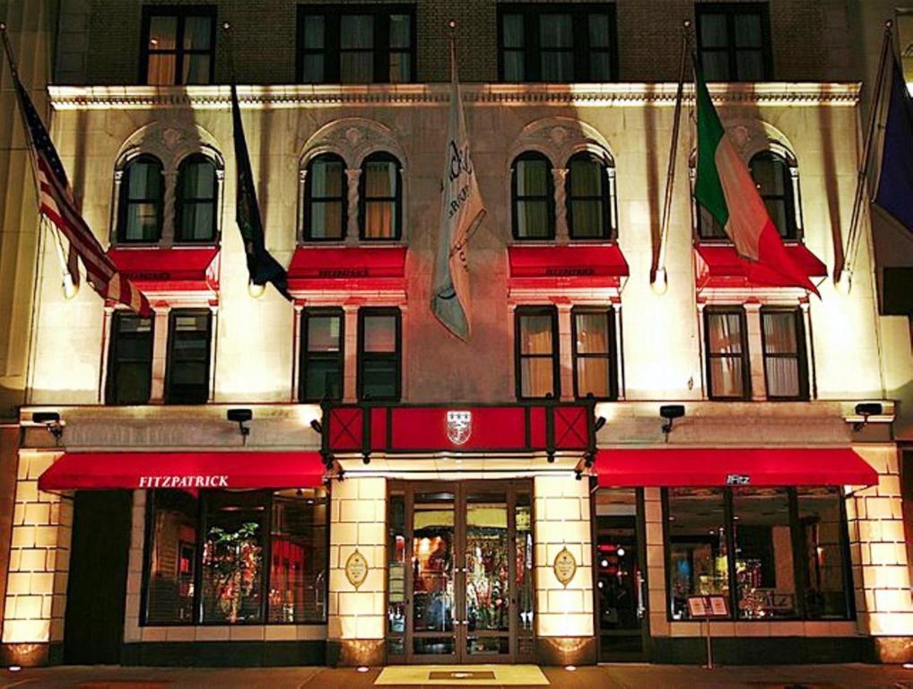 a building with flags in front of a store at Fitzpatrick Manhattan in New York