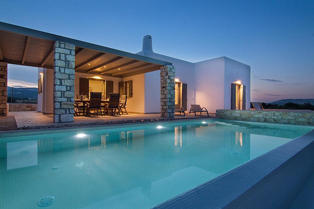 a swimming pool in front of a house at ILSOGNO VILLA in Mármara