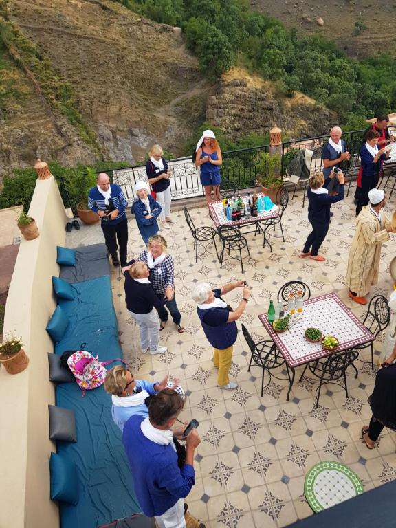a group of people standing on a patio at Toubkal Garden in Imlil