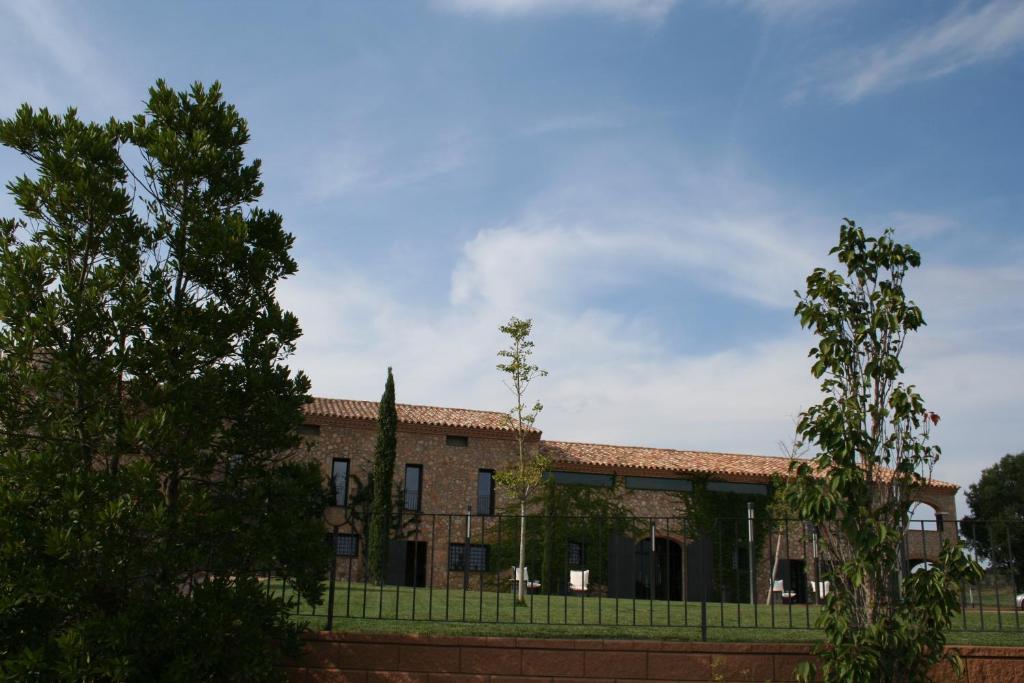 a building with a fence in front of it at Hotel Mas Oliveres Pla de Palau in Llers