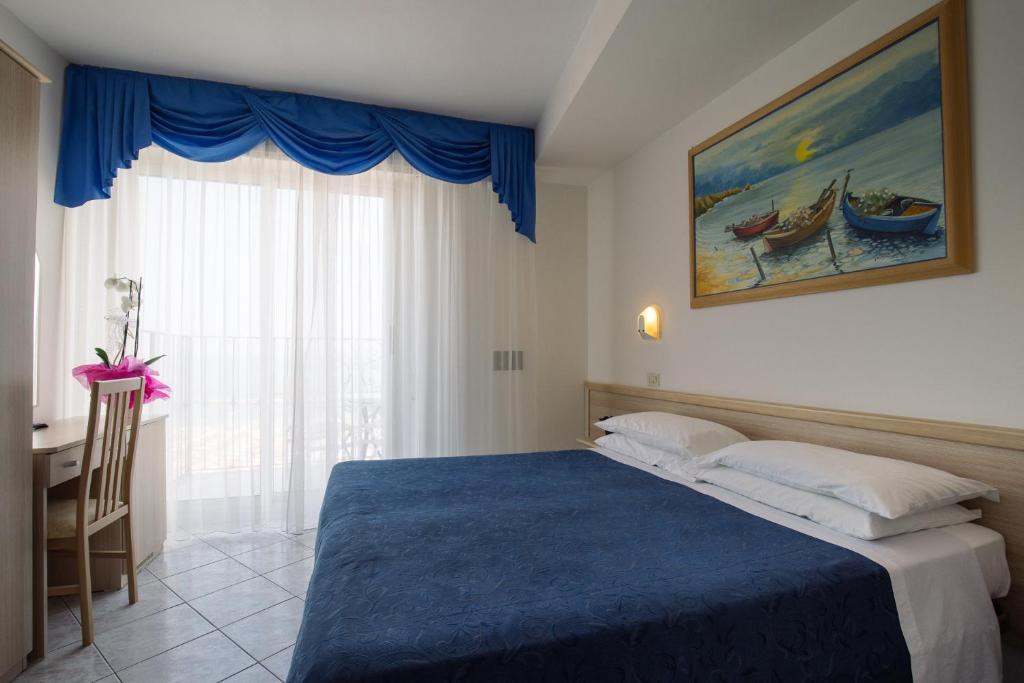 Postel nebo postele na pokoji v ubytování Hotel Lido
