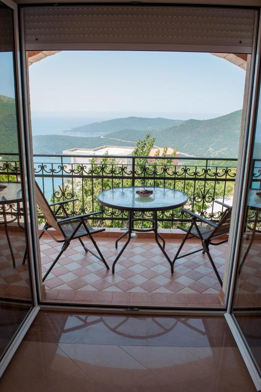 a patio with a table and chairs on a balcony at Apartments Villa Sveti Nikola in Budva