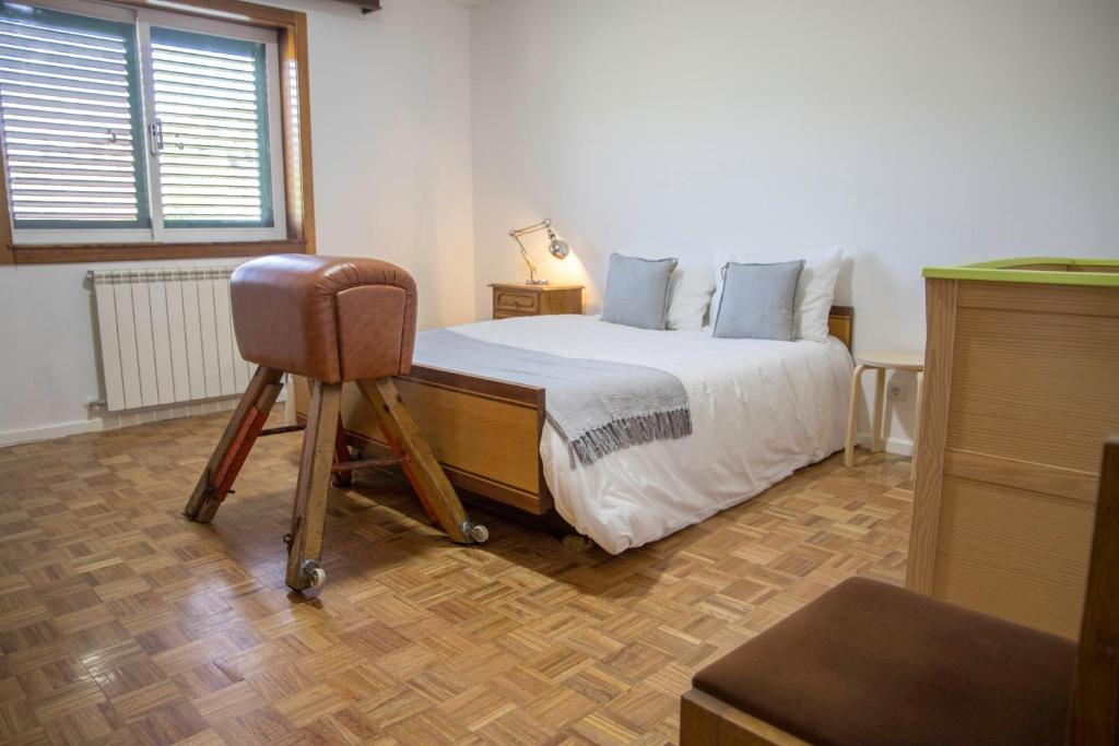 Ένα ή περισσότερα κρεβάτια σε δωμάτιο στο Casa do Luzio