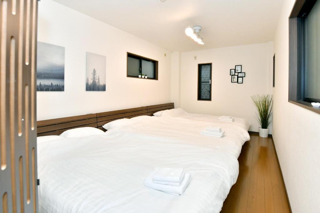 GUEST HOUSE OSAKA HAGINOCHAYA Vacation STAY 4271 tesisinde bir odada yatak veya yataklar