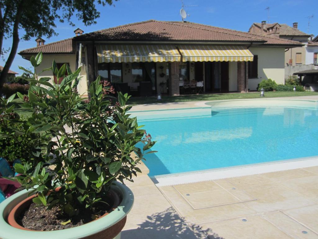 a villa with a swimming pool and a house at Marinella B&B in Cornale