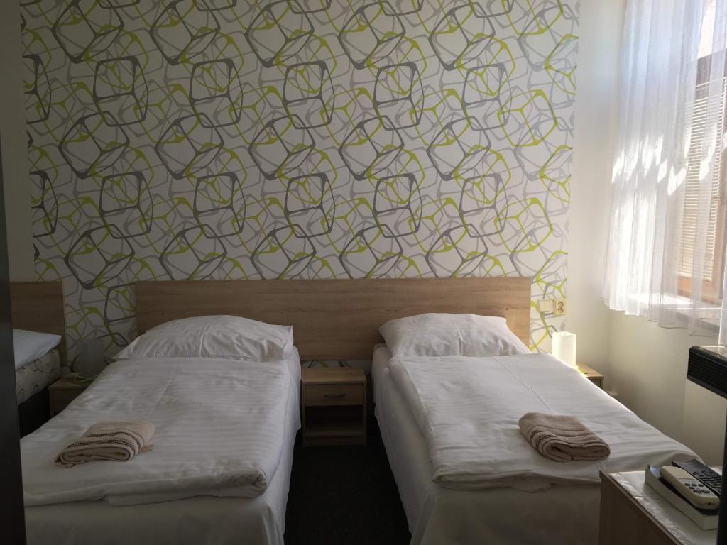 Postel nebo postele na pokoji v ubytování Hotel Jordánek