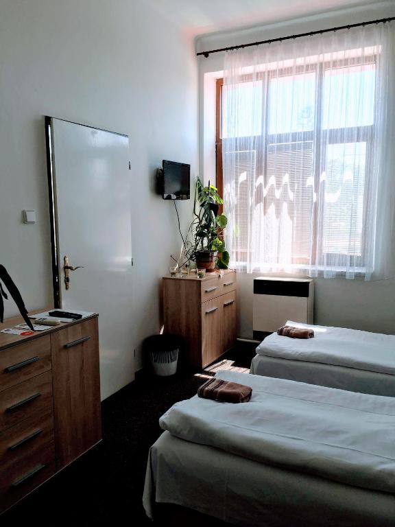 Postel nebo postele na pokoji v ubytování Hotel Jordánek