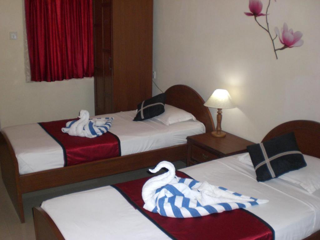 Кровать или кровати в номере A's Holiday Beach Resort