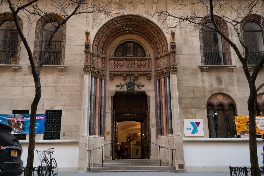 een gebouw met een grote ingang naar een gebouw bij West Side YMCA in New York