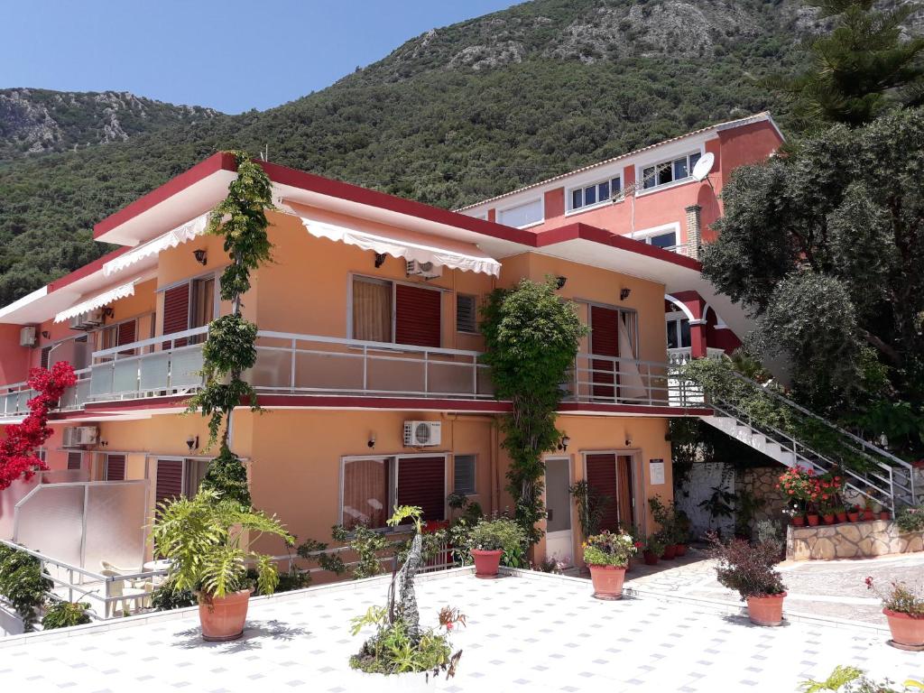 a building with a mountain in the background at EMILIOS SEE VIEW in Barbati