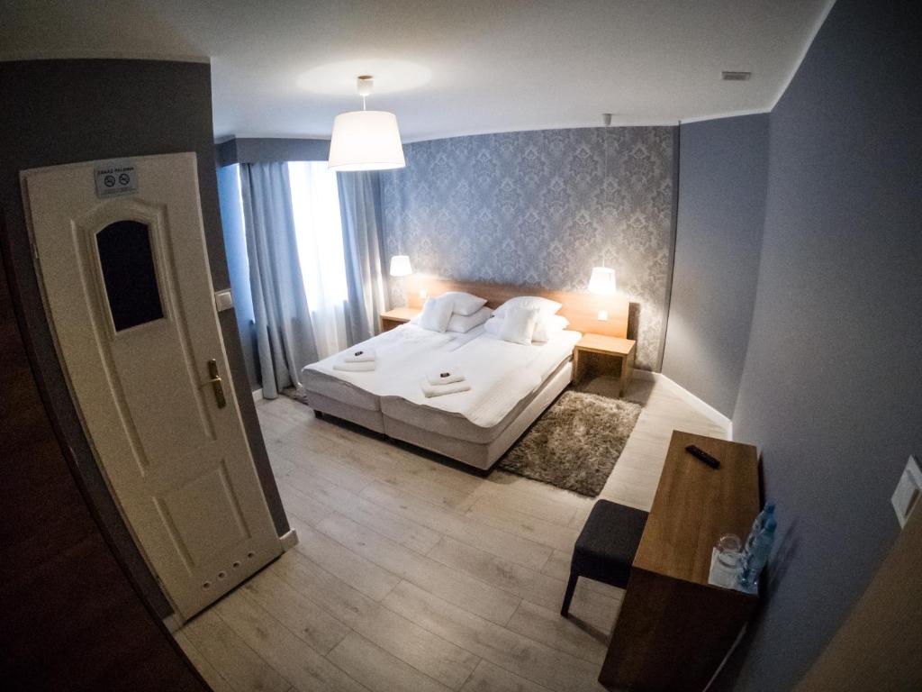 1 dormitorio con 1 cama y 1 dormitorio con mesa en Restauracja Pod Kogutem, en Poniatowa