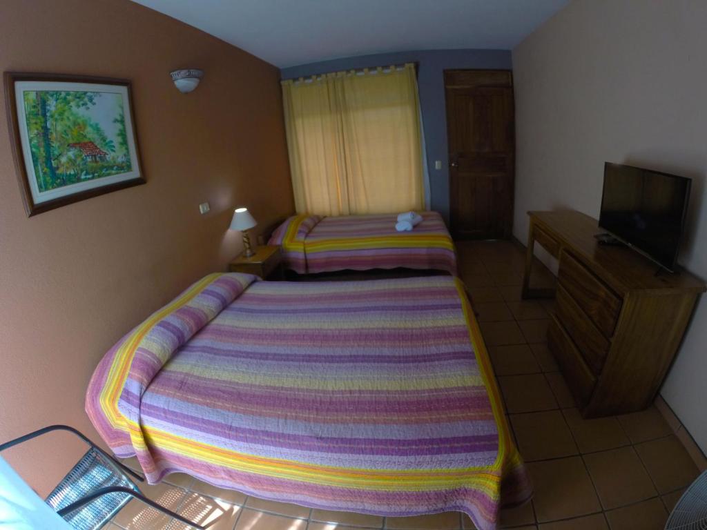 Postel nebo postele na pokoji v ubytování Hotel Guadalupe
