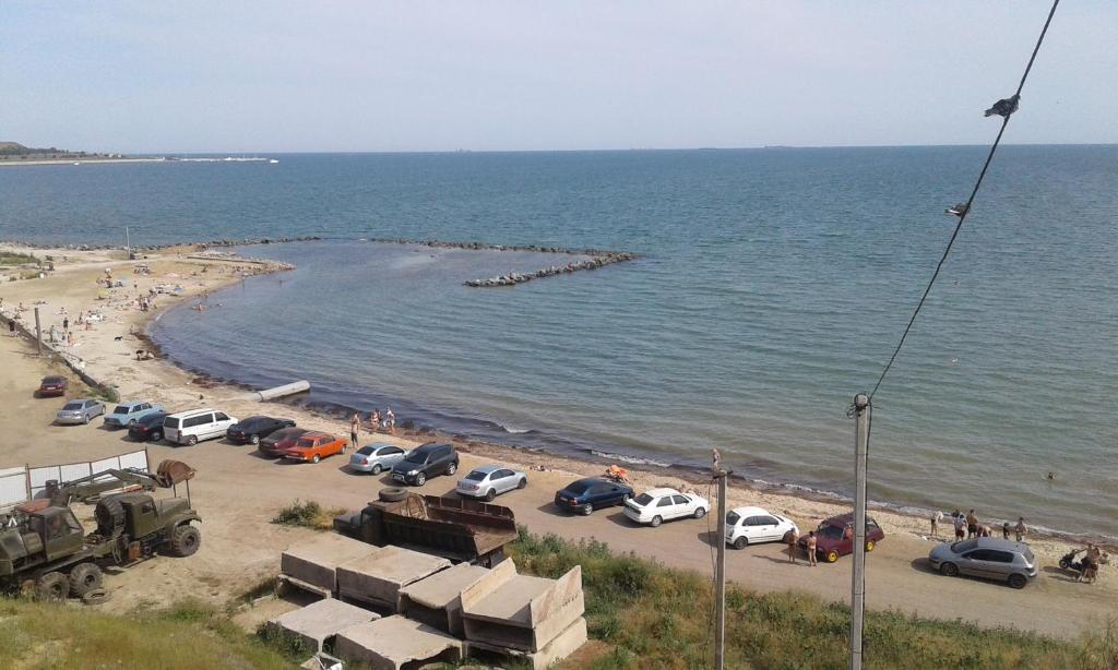 un grupo de coches estacionados en una playa junto al agua en Минигостиница, en Kryzhanivka