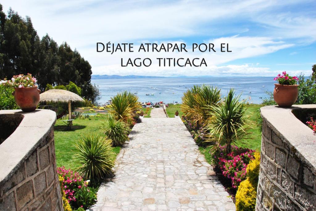 a walkway in a garden with a view of the ocean at Gloria Copacabana in Copacabana