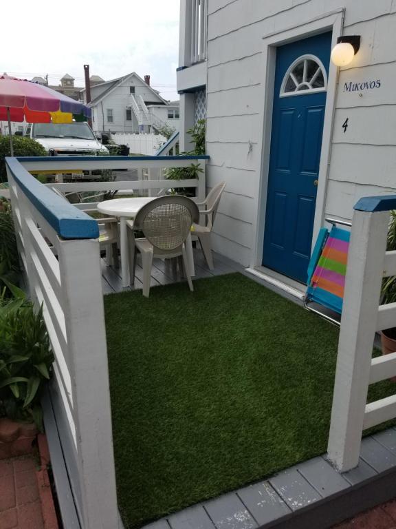 a patio with a table and a blue door at Anna's place in Ocean City