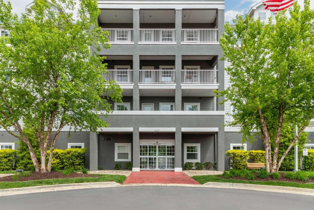 an apartment building with trees in front of it at MainStay Suites St Robert-Fort Leonard Wood in Saint Robert