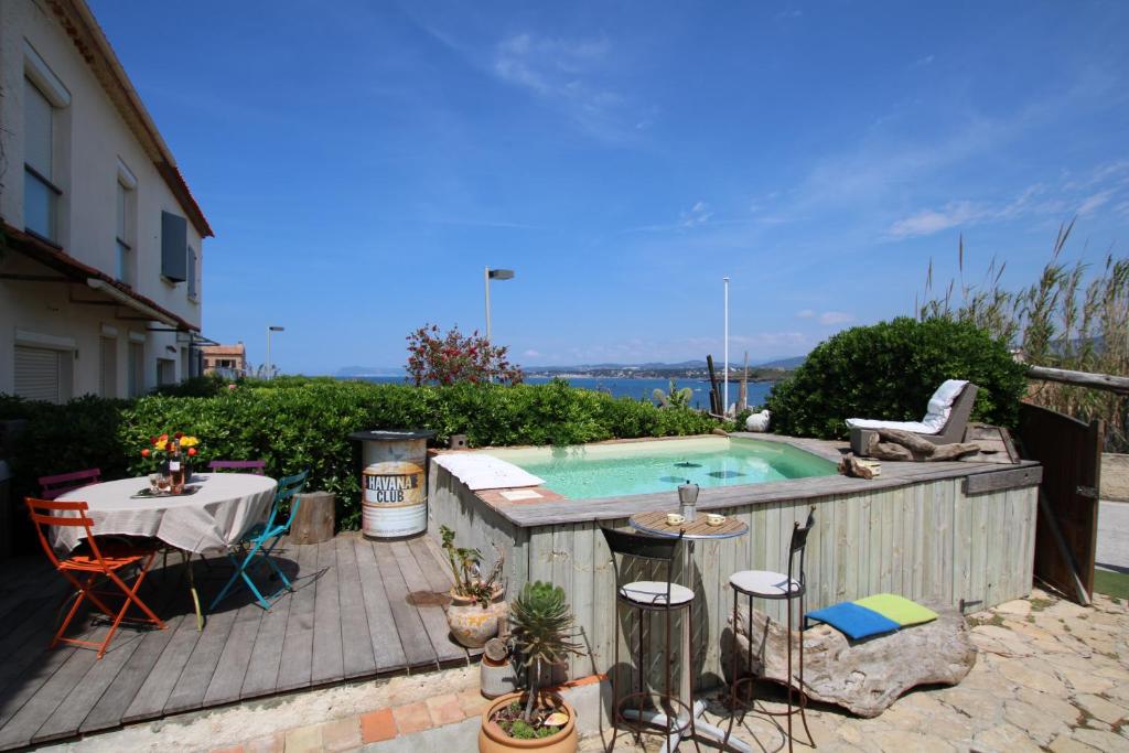 a backyard with a pool and a table and a table and chairs at un coin de paradis in Six-Fours-les-Plages