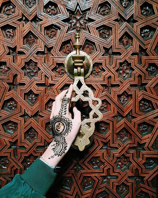 a hand holding a pair of scissors with henna on it at Riad Challa Hotel & Spa in Marrakesh