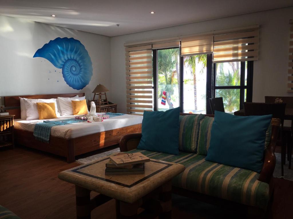 a living room with a bed and a couch at 357 Boracay Resort in Boracay