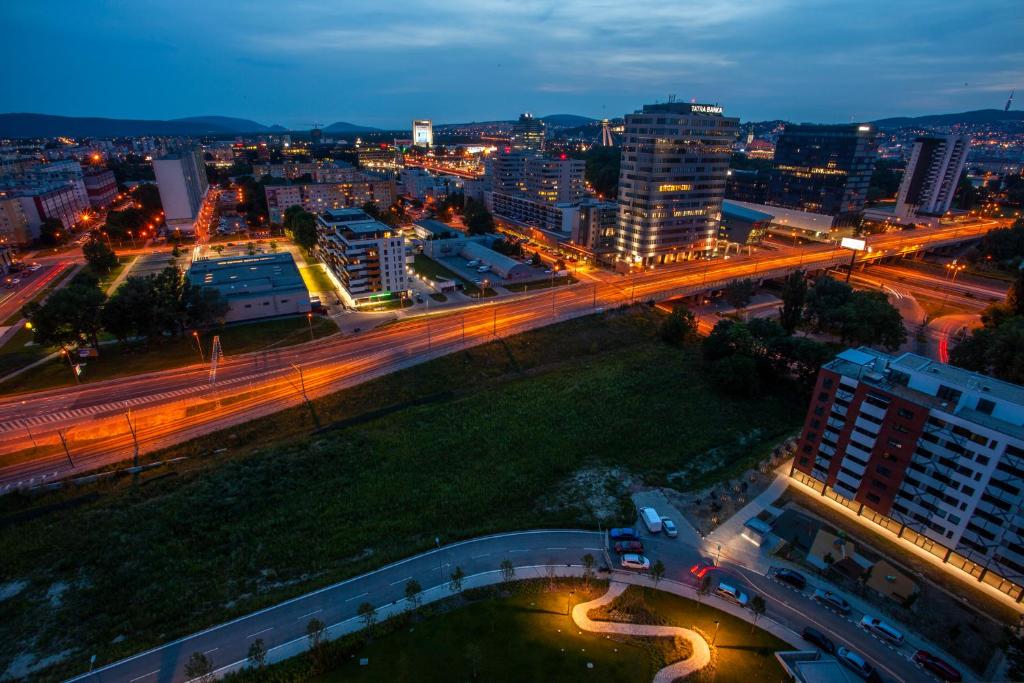 a city at night with a bridge and buildings at Air-Conditioned City View Apartment 24h check-in in Bratislava