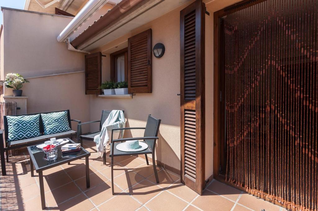 a patio with chairs and a table and a fence at Lets Holidays Heart of Tossa Apartment in Tossa de Mar