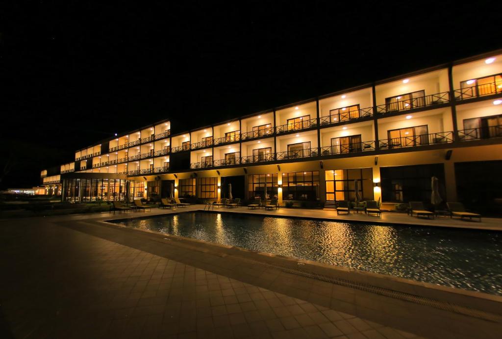 a building with a swimming pool at night at Haile Resort Arbaminch in Migie