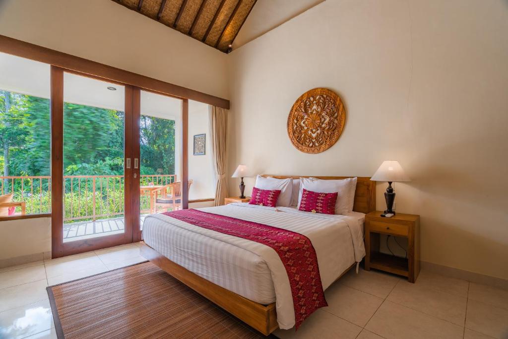 Postel nebo postele na pokoji v ubytování Swahita Ubud