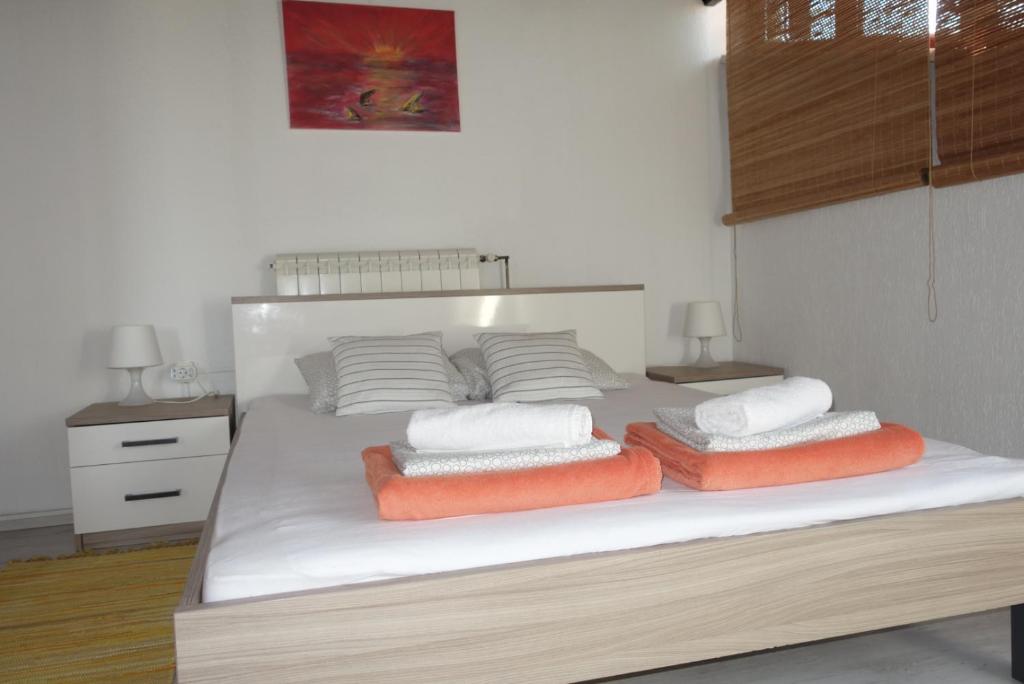 a bedroom with a bed with three pillows on it at Apartment Beli Kriz in Piran