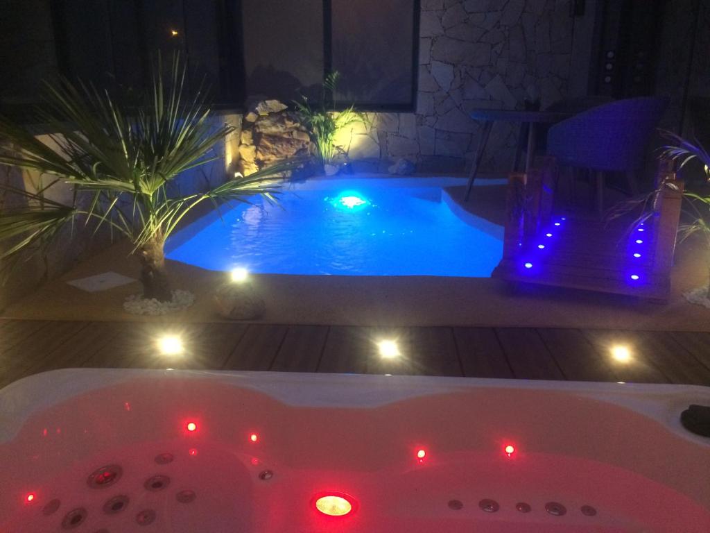 a bath tub with lights in front of a pool at B&B Villa sensorielle in Nice