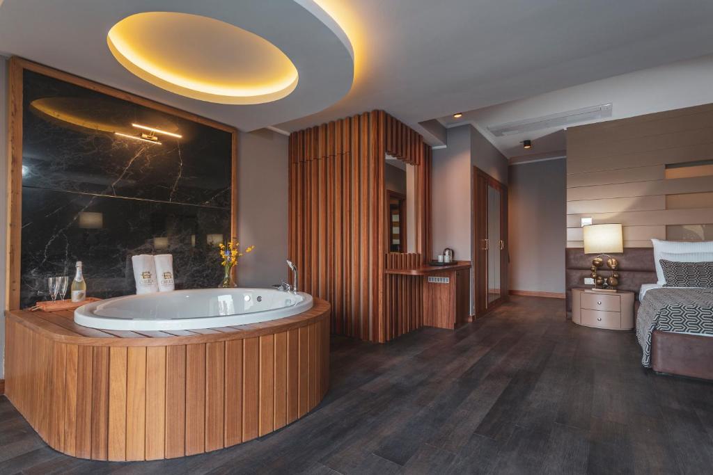 A bed or beds in a room at Orka Cove Hotel Penthouse & Suites Adults Only