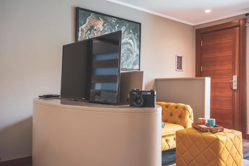 A television and/or entertainment centre at Orka Cove Hotel Penthouse & Suites Adults Only