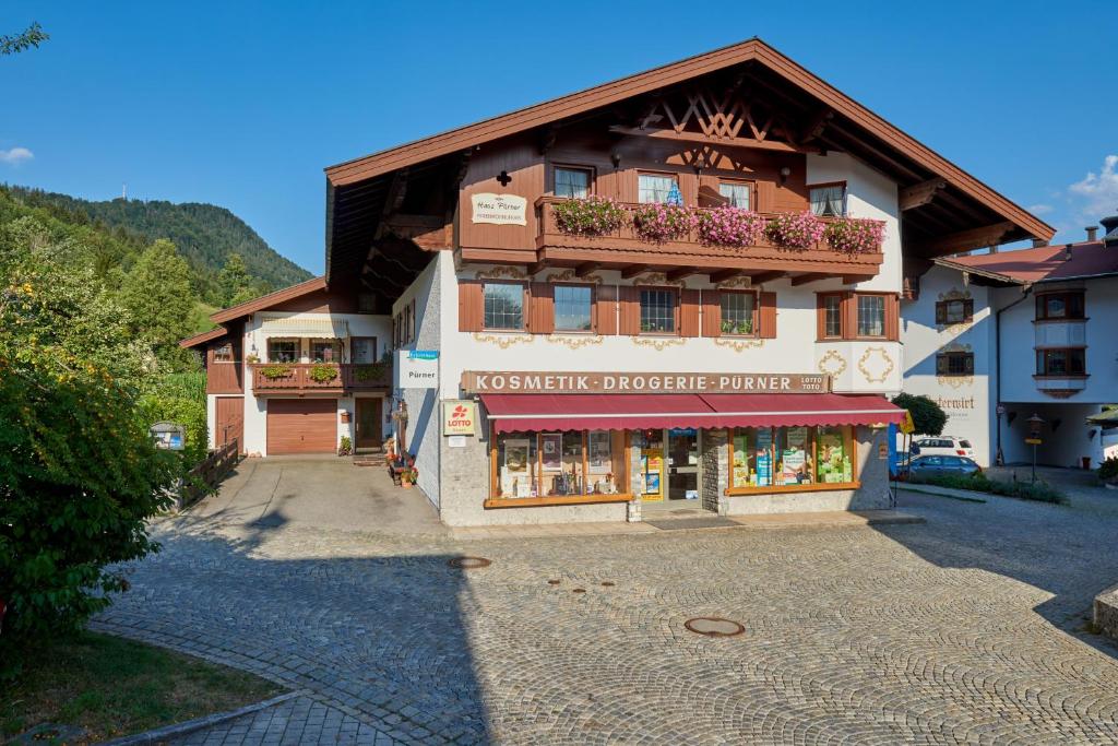 a large building with a store in front of it at Haus Pürner in Reit im Winkl