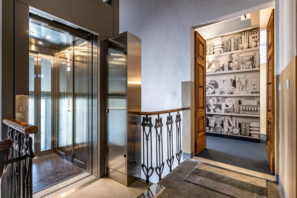a hallway with a walk in pantry with glass doors at Palazzo dei Conti Residenza d'Epoca in Florence