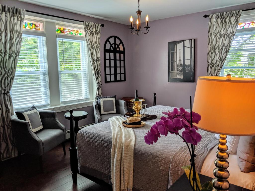 a bedroom with a bed and a table with a lamp at Chelsea Pub and Inn in Atlantic City