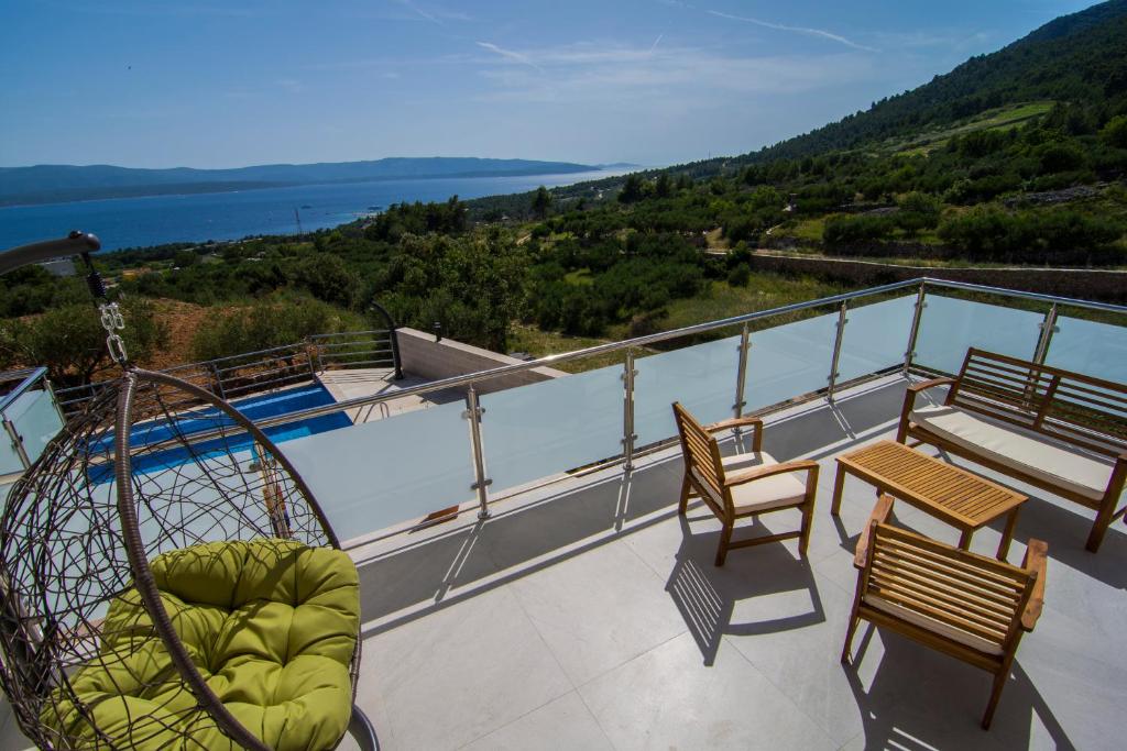 a balcony with a view of the water at Villa Nikola - big terrace apartments in Bol