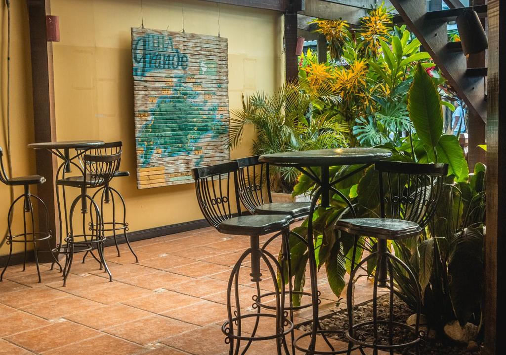 a patio with chairs and tables and plants at Lonier Nature INN in Abraão