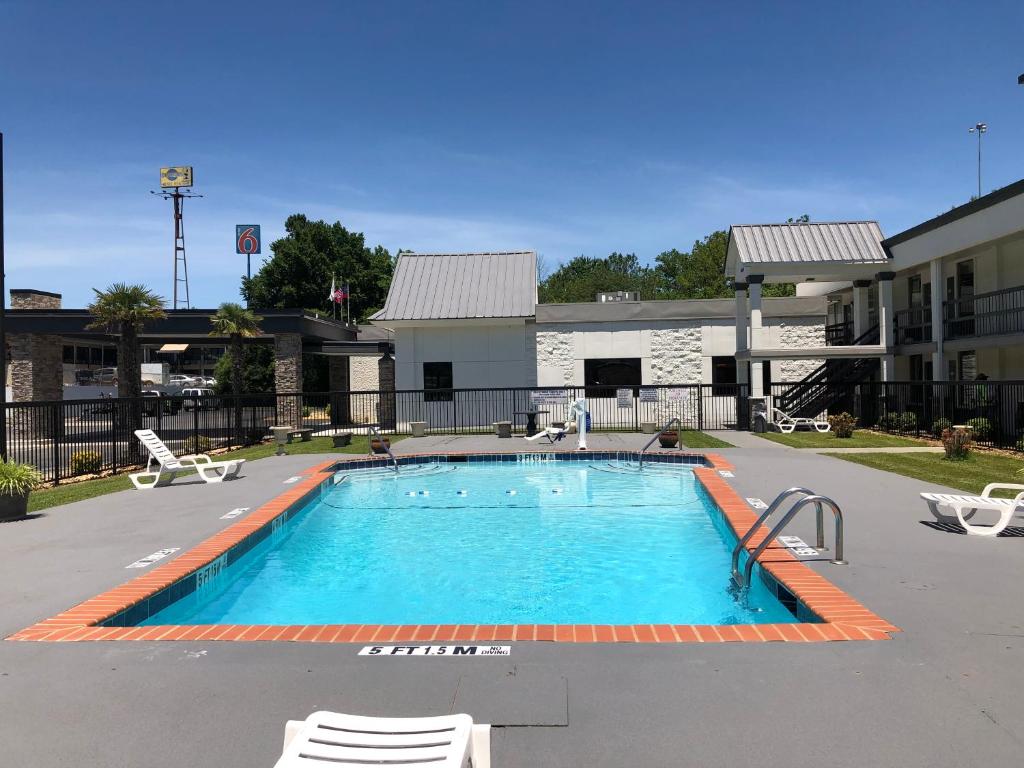 a large swimming pool in a parking lot at Quality Inn in Dalton