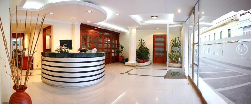 a lobby of a building with a large planter at Casa Madrigal Hotel in Pasto