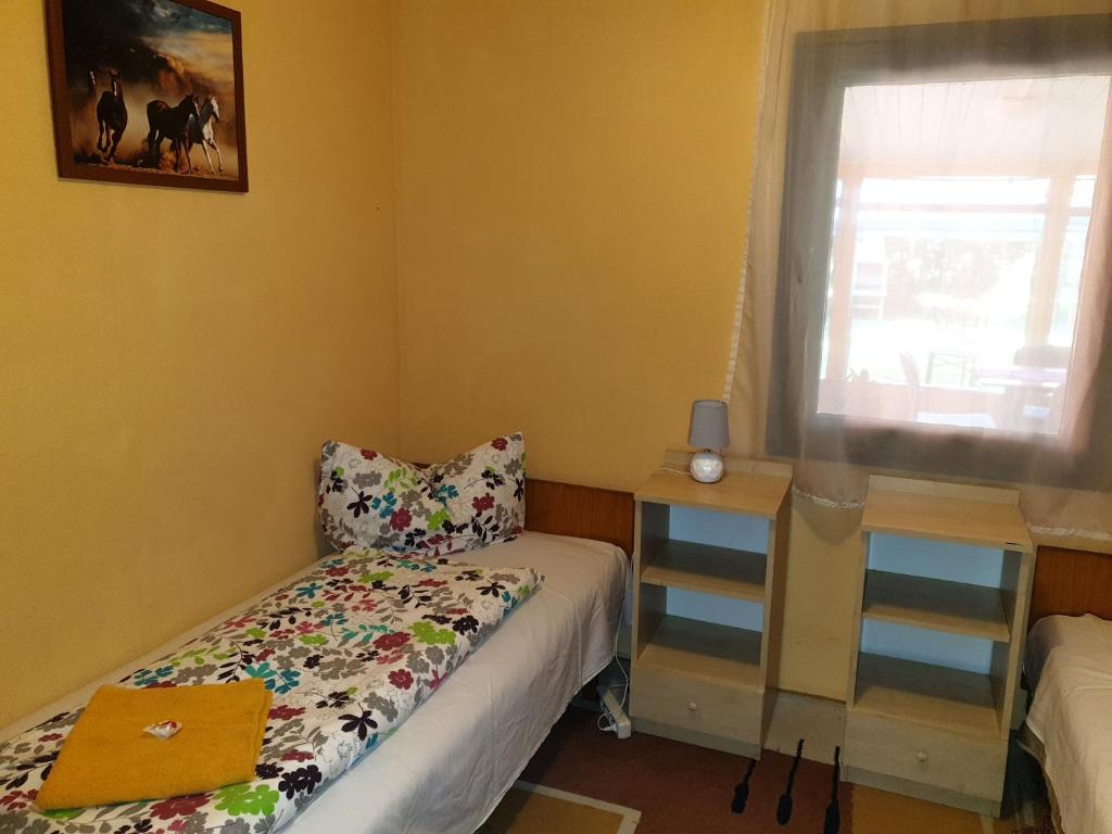 Postel nebo postele na pokoji v ubytování Rába Part Apartman